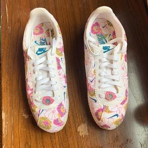 Size 8 Nike sneakers with pink, orange, yellow and blue flower print.